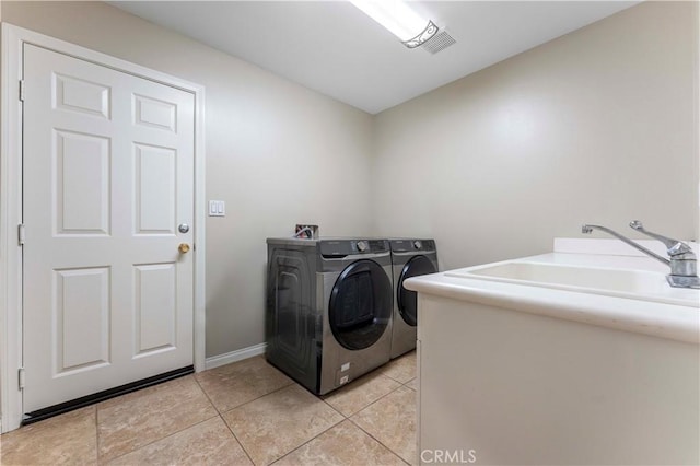 12178 Scenic Vw, Riverside, CA 92505 - washroom featuring washing machine and clothes dryer, light tile patterned floors, and baseboards
