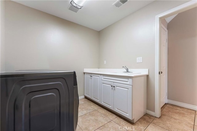 12178 Scenic Vw, Riverside, CA 92505 - laundry area with baseboards, cabinet space, and light tile patterned flooring