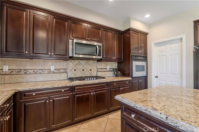 12178 Scenic Vw, Riverside, CA 92505 - kitchen featuring stainless steel appliances, backsplash, light tile patterned floors, dark brown cabinetry, and recessed lighting