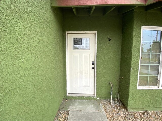 9602 Ives St, Bellflower, CA 90706 - view of exterior entry featuring stucco siding