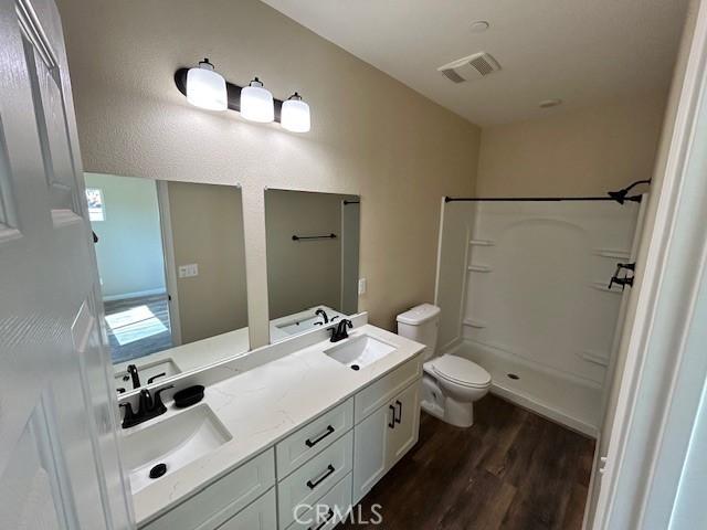 1488 Bille Rd, Paradise, CA 95969 - bathroom featuring wood finished floors, a shower, and double vanity