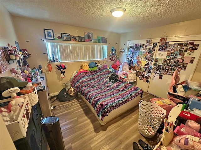 7534 Layton St, Rancho Cucamonga, CA 91730 - bedroom with wood finished floors, freestanding refrigerator, and a textured ceiling