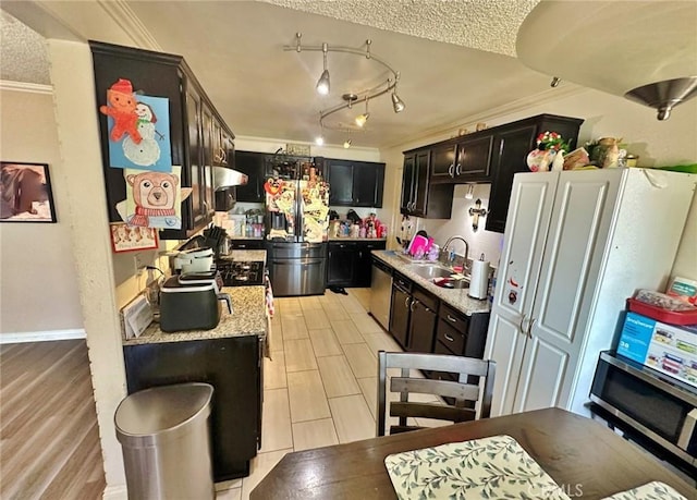 7534 Layton St, Rancho Cucamonga, CA 91730 - kitchen with appliances with stainless steel finishes, crown molding, a textured ceiling, a sink, and dark cabinets