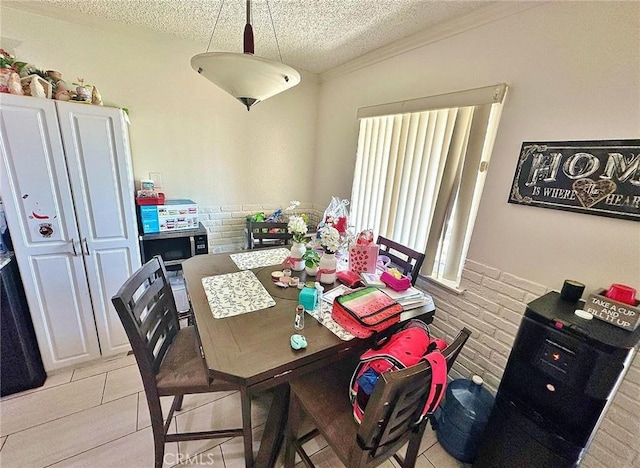 7534 Layton St, Rancho Cucamonga, CA 91730 - dining room featuring a textured ceiling, light tile patterned floors, and wainscoting