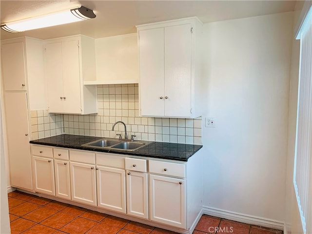 10241 Ruoff Ave, Whittier, CA 90604 - kitchen featuring a sink, light tile patterned flooring, backsplash, and white cabinets