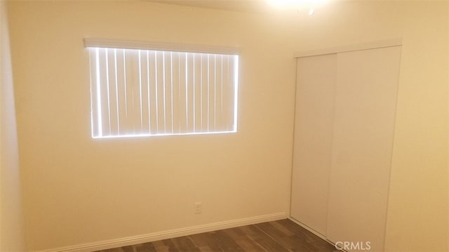 10241 Ruoff Ave, Whittier, CA 90604 - empty room with dark wood-type flooring and baseboards