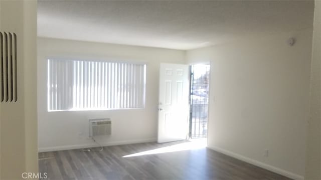 10241 Ruoff Ave, Whittier, CA 90604 - empty room featuring wood finished floors, healthy amount of natural light, and baseboards