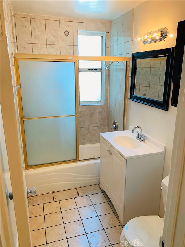 10241 Ruoff Ave, Whittier, CA 90604 - bathroom featuring toilet, combined bath / shower with glass door, vanity, and tile patterned flooring
