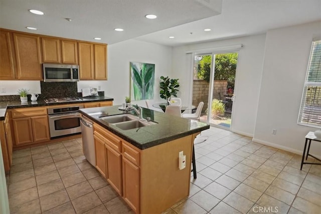 27045 Fairway Ln, Valencia, CA 91381 - kitchen featuring stainless steel appliances, light tile patterned flooring, an island with sink, a breakfast bar area, and recessed lighting