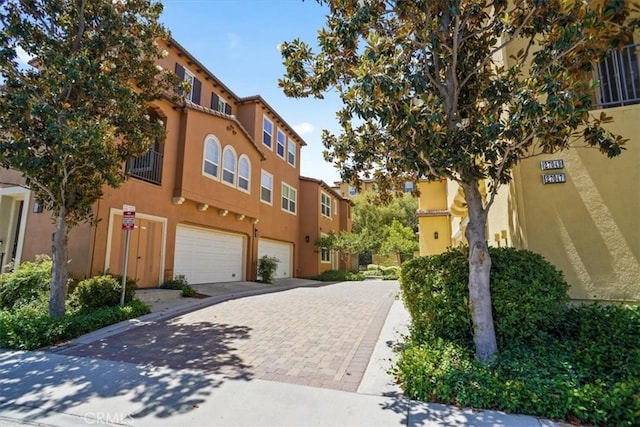 27045 Fairway Ln, Valencia, CA 91381 - view of building exterior featuring an attached garage and decorative driveway
