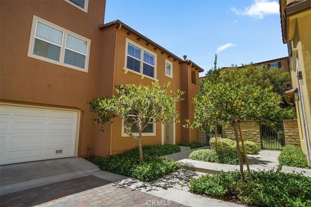 27045 Fairway Ln, Valencia, CA 91381 - exterior space featuring a garage, stucco siding, and driveway