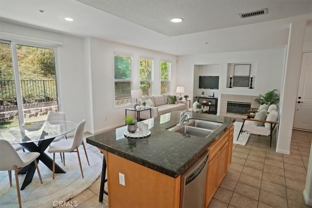 27045 Fairway Ln, Valencia, CA 91381 - kitchen featuring dishwasher, plenty of natural light, a tiled fireplace, light tile patterned flooring, and recessed lighting