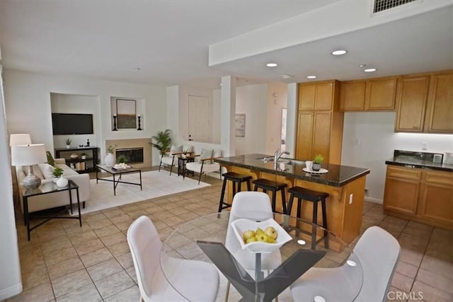 27045 Fairway Ln, Valencia, CA 91381 - dining space featuring light tile patterned floors, recessed lighting, and a glass covered fireplace