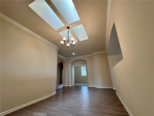 24212 Nobe St, Corona, CA 92883 - unfurnished living room featuring a skylight, arched walkways, a chandelier, wood finished floors, and crown molding
