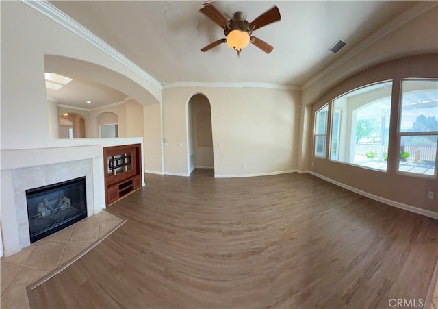 24212 Nobe St, Corona, CA 92883 - unfurnished living room featuring wood finished floors, ceiling fan, crown molding, baseboards, and a tile fireplace