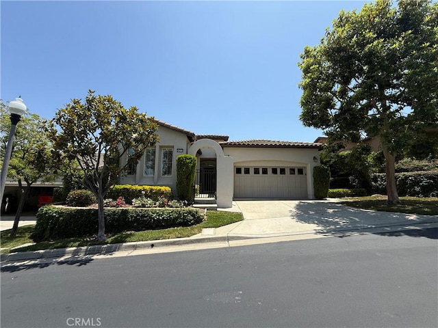 24212 Nobe St, Corona, CA 92883 - mediterranean / spanish home featuring a garage, stucco siding, concrete driveway, and a tiled roof