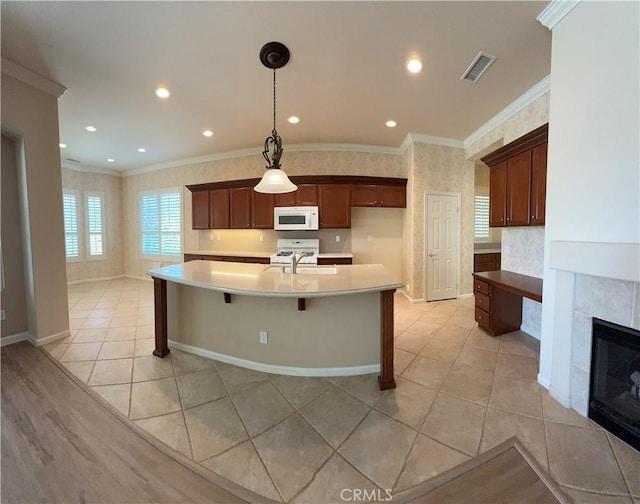 24212 Nobe St, Corona, CA 92883 - kitchen with white microwave, crown molding, light tile patterned floors, light countertops, and a sink