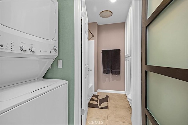 1040 Central Ave Unit 10, Riverside, CA 92507 - laundry room featuring stacked washer / drying machine, light tile patterned floors, and baseboards