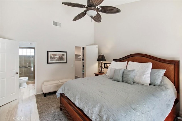 40425 Pebble Beach Cir, Palm Desert, CA 92211 - bedroom featuring a walk in closet, a towering ceiling, connected bathroom, and a ceiling fan