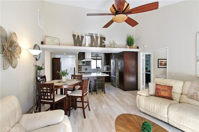 40425 Pebble Beach Cir, Palm Desert, CA 92211 - living room featuring a high ceiling, light wood-style floors, and a ceiling fan