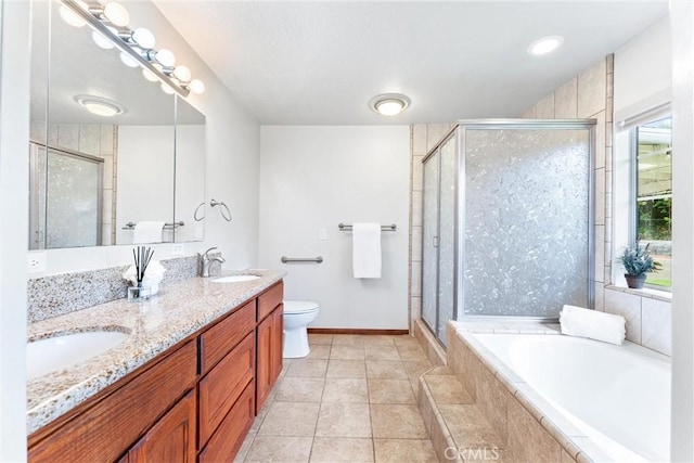 9818 Capulet Ave, Whittier, CA 90603 - bathroom with double vanity, a garden tub, a shower stall, toilet, and baseboards