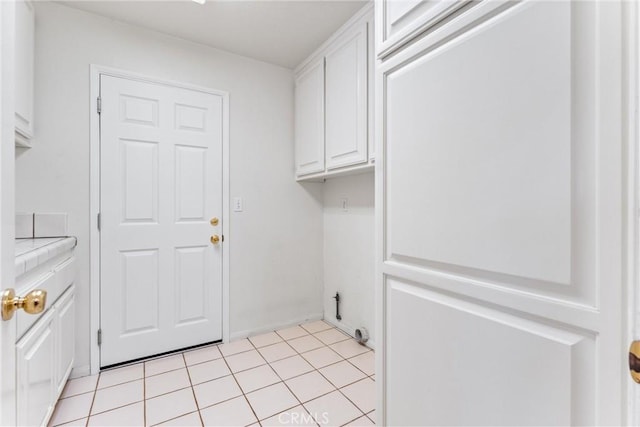 9818 Capulet Ave, Whittier, CA 90603 - laundry room with cabinet space, electric dryer hookup, and light tile patterned floors