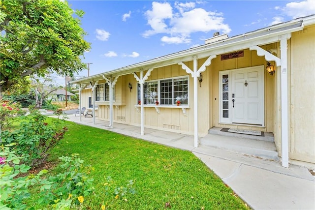 9818 Capulet Ave, Whittier, CA 90603 - doorway to property featuring board and batten siding and a lawn