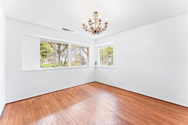9818 Capulet Ave, Whittier, CA 90603 - spare room featuring a chandelier, hardwood / wood-style floors, and baseboards