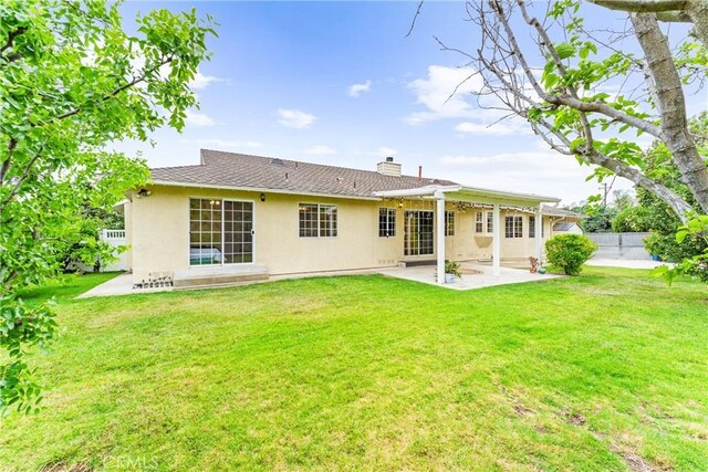 9818 Capulet Ave, Whittier, CA 90603 - rear view of property featuring a patio area, stucco siding, and a chimney