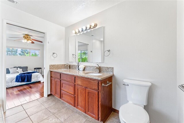 9818 Capulet Ave, Whittier, CA 90603 - ensuite bathroom featuring double vanity, healthy amount of natural light, tile patterned flooring, and toilet