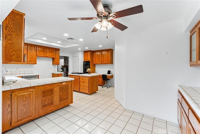 9818 Capulet Ave, Whittier, CA 90603 - kitchen featuring black oven, tile countertops, recessed lighting, brown cabinetry, and a ceiling fan
