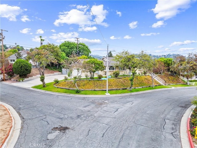9818 Capulet Ave, Whittier, CA 90603 - view of property hidden behind natural elements with driveway and a garage