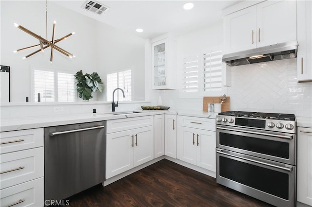 1617 S Beverly Glen Blvd Unit 301, Los Angeles, CA 90024 - kitchen with appliances with stainless steel finishes, under cabinet range hood, a sink, a chandelier, and backsplash