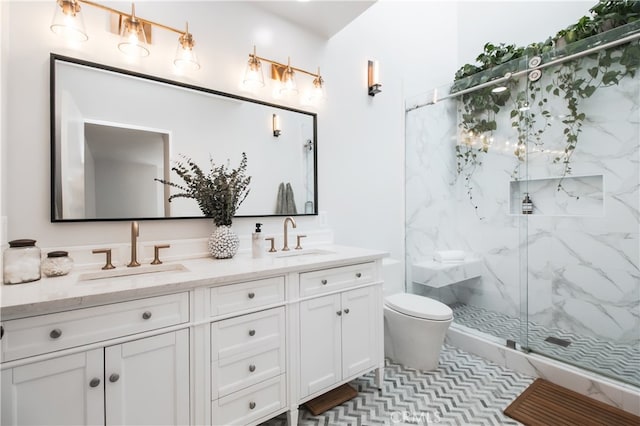 1617 S Beverly Glen Blvd Unit 301, Los Angeles, CA 90024 - bathroom with a marble finish shower, double vanity, and toilet