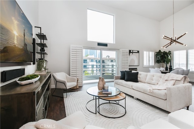 1617 S Beverly Glen Blvd Unit 301, Los Angeles, CA 90024 - living area with a towering ceiling, wood finished floors, a chandelier, and baseboards