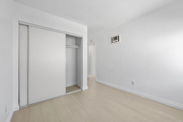 3468 Los Mochis Way, Oceanside, CA 92056 - unfurnished bedroom with wood finished floors, a closet, and baseboards