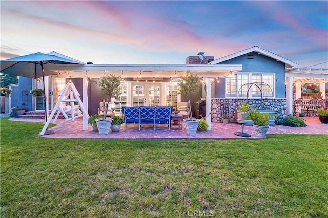 210 View Dr, La Habra, CA 90631 - back of property featuring a patio area, a chimney, stucco siding, a lawn, and outdoor lounge area