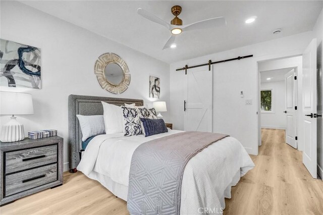 2842 E Virginia Ave, Anaheim, CA 92806 - bedroom with light wood-style floors, a barn door, a ceiling fan, recessed lighting, and baseboards
