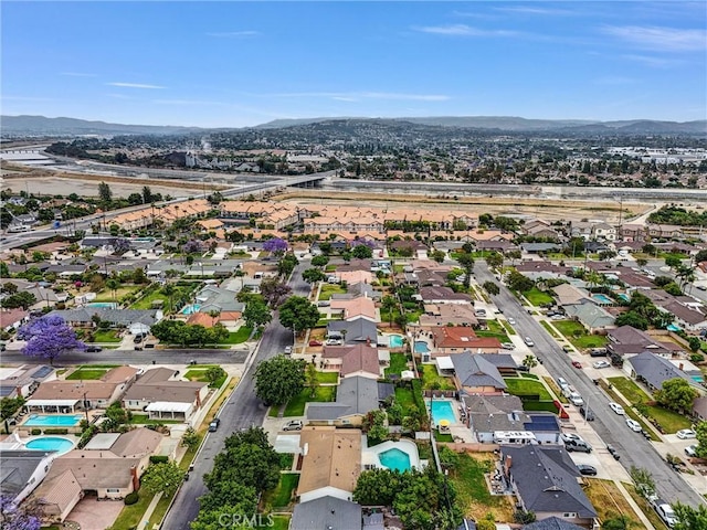 2842 E Virginia Ave, Anaheim, CA 92806 - aerial view of property's location featuring a pool area, a mountainous background, and nearby suburban area