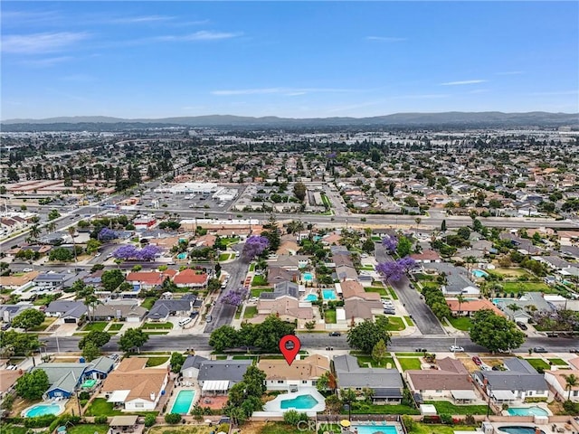 2842 E Virginia Ave, Anaheim, CA 92806 - aerial view of property's location with a mountain backdrop, a pool, and nearby suburban area
