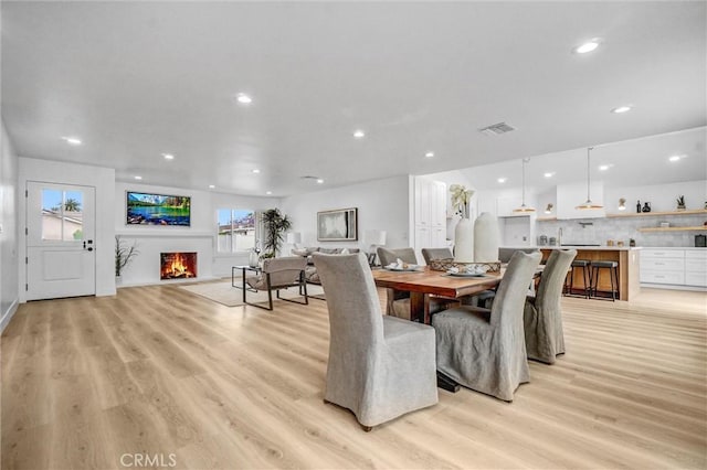 2842 E Virginia Ave, Anaheim, CA 92806 - dining area with light wood finished floors, recessed lighting, and a lit fireplace