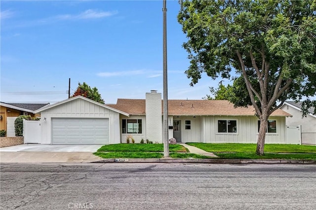 2842 E Virginia Ave, Anaheim, CA 92806 - ranch-style house with a chimney, a garage, driveway, and a front lawn