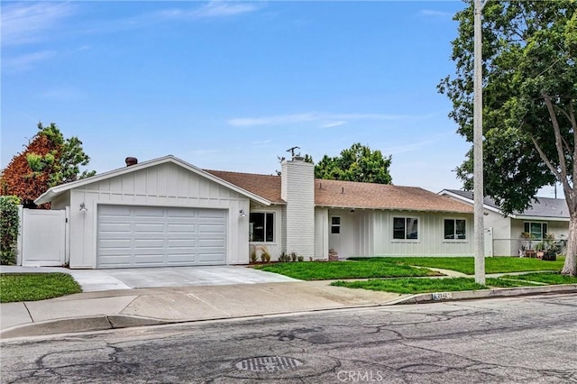 2842 E Virginia Ave, Anaheim, CA 92806 - ranch-style home featuring a chimney, a garage, driveway, and board and batten siding
