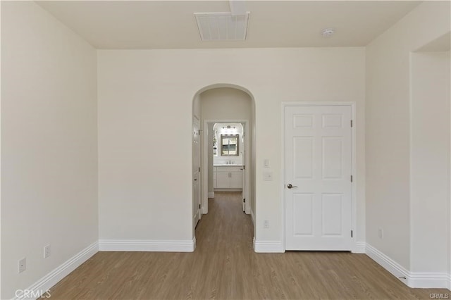 4304 Owens St Unit 102, Corona, CA 92883 - empty room with arched walkways, wood finished floors, and a smoke detector