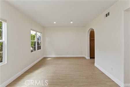 4304 Owens St Unit 102, Corona, CA 92883 - spare room with arched walkways, light wood-style flooring, plenty of natural light, and recessed lighting