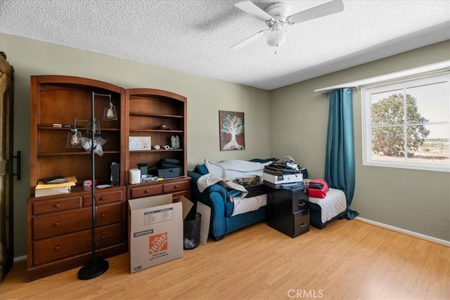 22025 Del Oro Rd, Apple Valley, CA 92308 - bedroom with a textured ceiling, light wood finished floors, baseboards, and ceiling fan