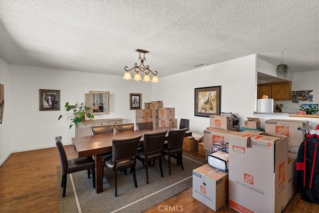 22025 Del Oro Rd, Apple Valley, CA 92308 - dining room featuring wood finished floors, a chandelier, and a textured ceiling