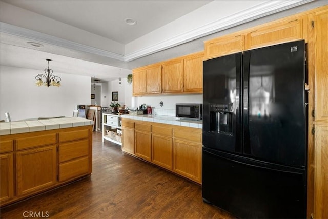 22025 Del Oro Rd, Apple Valley, CA 92308 - kitchen featuring black refrigerator with ice dispenser, tile counters, dark wood-type flooring, a chandelier, and hanging light fixtures