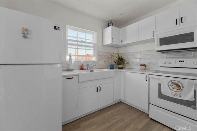 22025 Del Oro Rd, Apple Valley, CA 92308 - kitchen with white appliances, a sink, light countertops, tasteful backsplash, and white cabinets