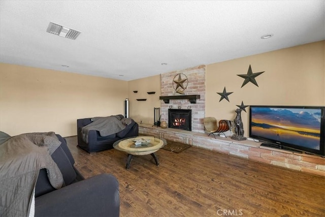 22025 Del Oro Rd, Apple Valley, CA 92308 - living area featuring a fireplace, wood finished floors, and a textured ceiling